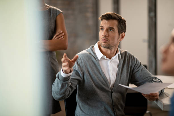 istock Businessman participating in a discussion during a presentation in the office. 1131036460