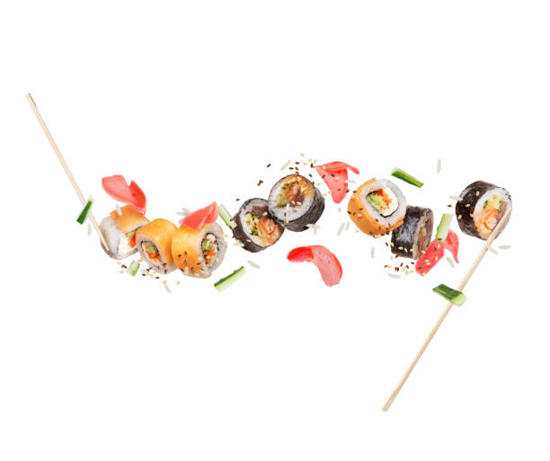 istock Fresh different sushi rolls with ginger frozen in the air on white background 1131036710