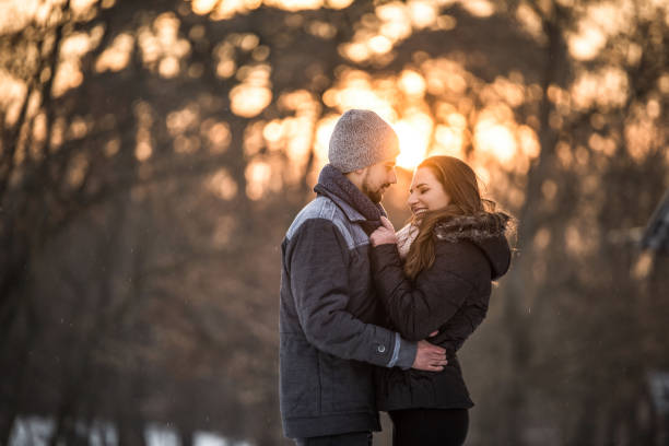 istock Happy young couple embracing on sunset on a cold winter day. 1131037733