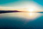 Dreamy sunset over ocean coastline - aerial view with copy space