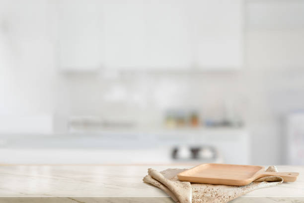 istock Brown wooden plate on marble counter table top in kitchen room 1131047921