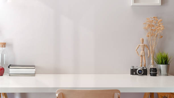 istock Contemporary minimal workspace with white wooden table and copy space 1131047951