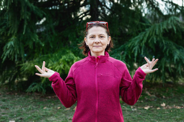 istock Woman using American sign language - hand gesture, phrase what's up 1131048734