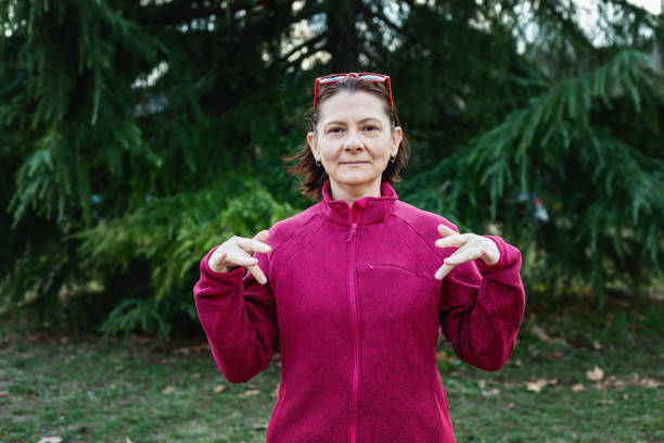 istock Woman using American sign language - hand gesture, phrase what's up 1131048780
