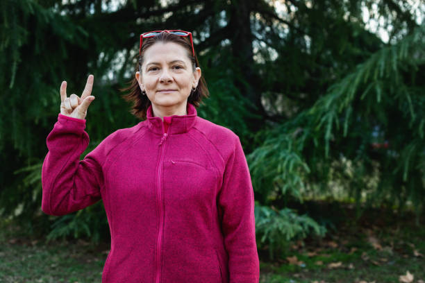 istock Woman using American sign language - hand gesture I love you 1131048854