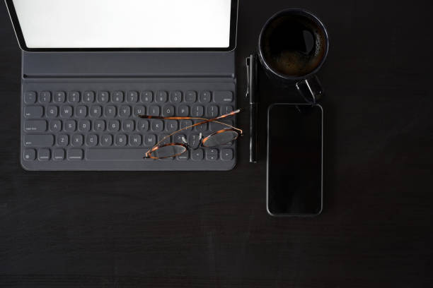 istock Business Items tablet, pen, mobile phone  on dark wood workspace table and copy space 1131049707