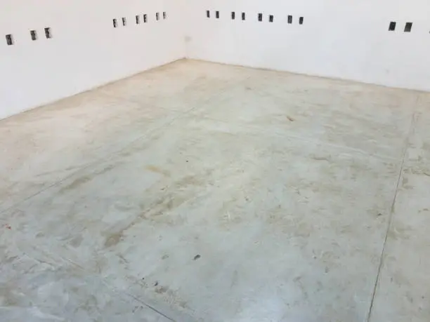 Photo of cement floor and white wall