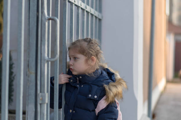 istock Little girl and an iron gate 1131050609