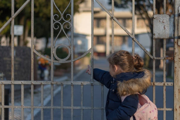 istock Little girl and an iron gate 1131050679