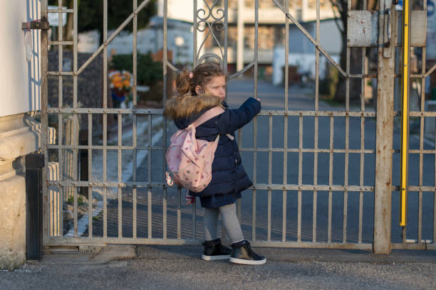 istock Little girl and an iron gate 1131050699