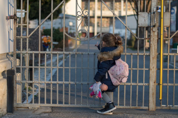 istock Little girl and an iron gate 1131050709