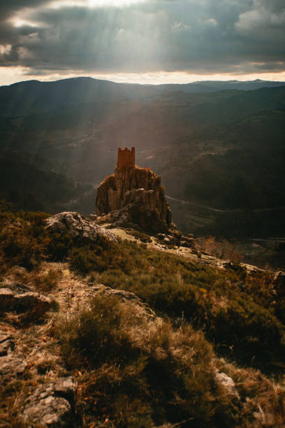 istock Lightbeam shining on medieval tower ruins built on a rock 1131053850
