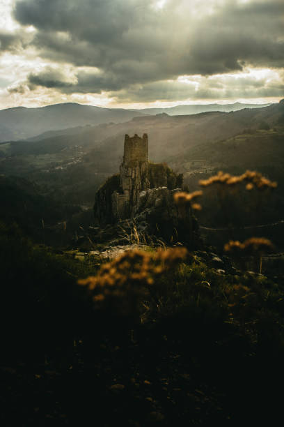 istock Lightbeam shining on medieval tower ruins built on a rock 1131053949