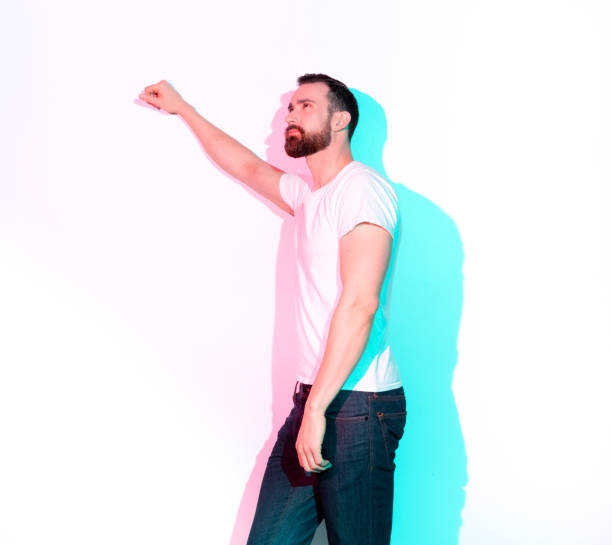 istock Handsome man standing with white shirt on white background 1131055409