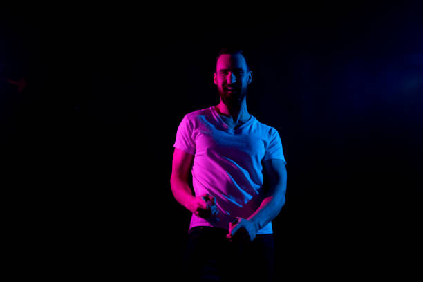 istock Handsome man in white tshirt with gel lighting 1131055653