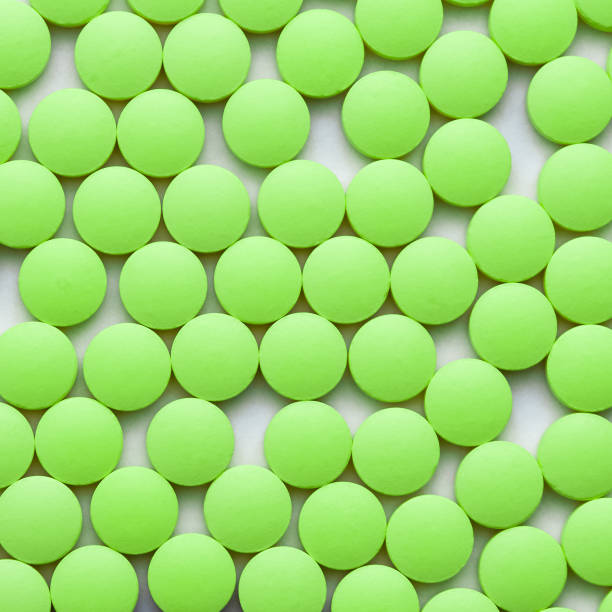 istock Small green pills on a white background close-up. 1131062695