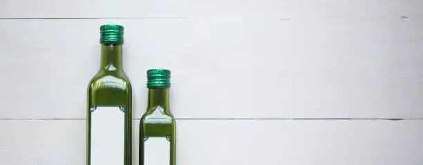 Photo of Green bottle for olive oil with white blank sticker for your text or design