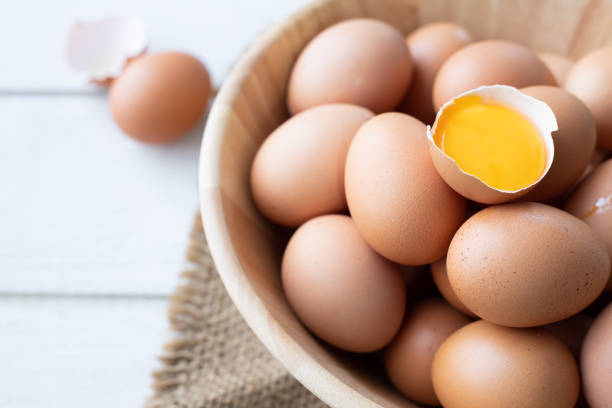 istock kitchen wood table with close up of egg in basket. 1131067775