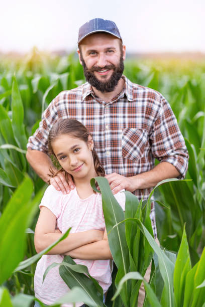 istock Young farmer and a girl in a cornfield 1131070712