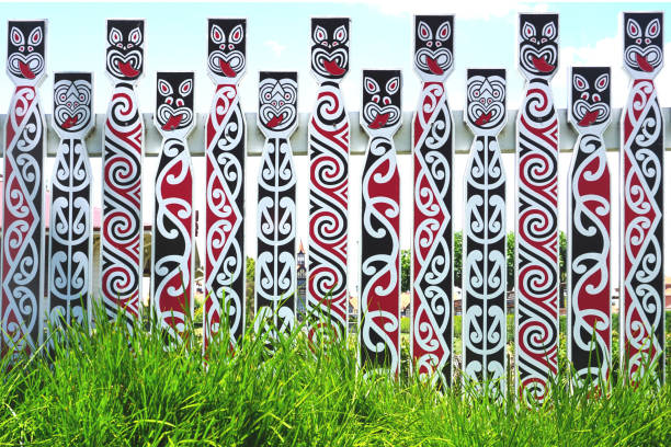 Fence with traditional Maori faces Fence with traditional Maori faces koru pattern stock pictures, royalty-free photos & images