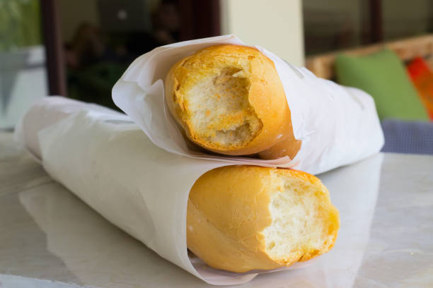 Two freshly backed golden loaves with two bites