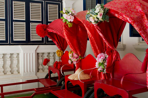 Three traditional rickshaw awaiting at the entrance of Chinpracha house in Phuket stock photo