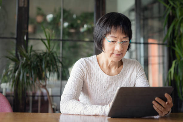 istock Senior Chinese woman using a digital tablet 1131076037