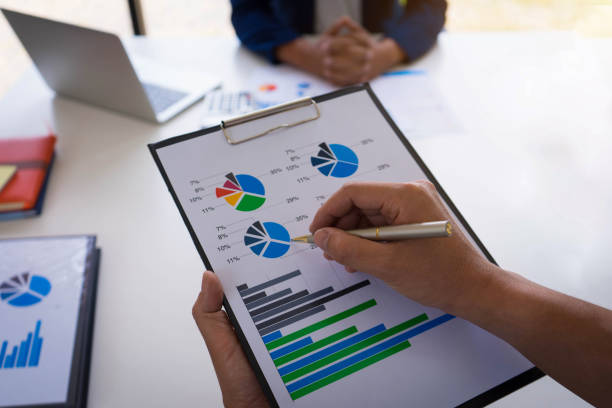 istock Businessman hand holding pen pointing business document and analysis data the charts and graphs showing the results at meeting.Business finances and accounting concept. 1131079521