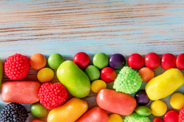 istock Bright colored candy on a blue wooden background with copyspace 1131080462