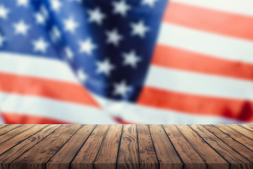 Us flag on a wooden old table. Concept of the 4th of July celebration