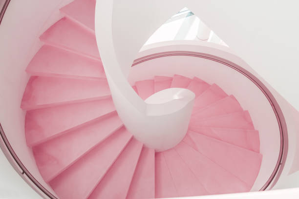 istock Pink living coral modern spiral staircase descent 1131083641