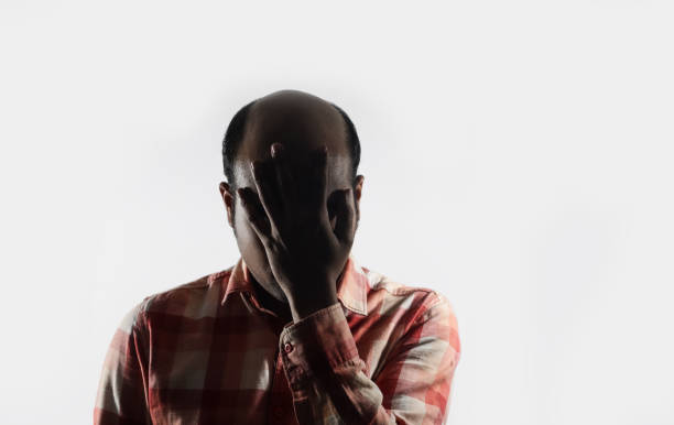istock bald man covering his face in shame in white background with space for text 1131083715