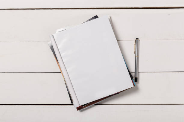 istock Mock-up magazine or catalog on wooden table. Blank page or notepad on wood background. Blank page or notepad for mockups or simulations 1131085255
