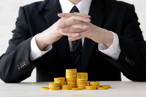 istock Business man and piled coin 1131085335