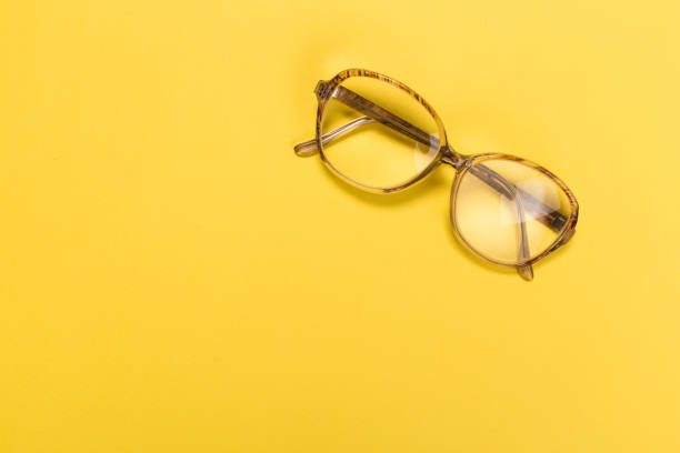 istock old glasses on a pastel yellow background 1131085366