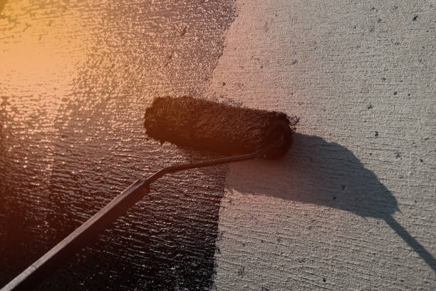 istock Roofer worker painting black coal tar or bitumen 1131086720