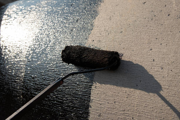 istock Roofer worker painting black coal tar or bitumen 1131086729