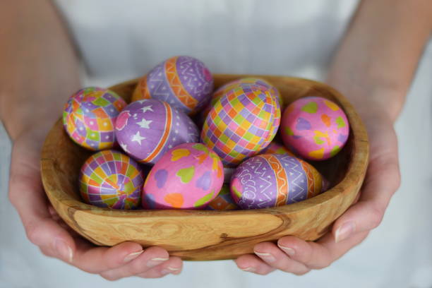 istock Easter eggs in bowl in woman hands 1131092894