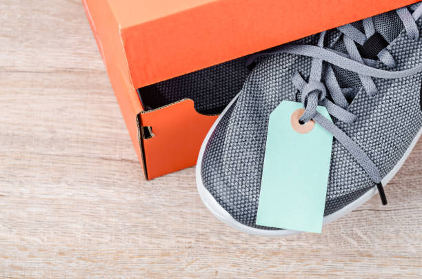 New collection of female sport shoes. New orange gumshoes isolated on white background, top view. Female txtile sneakers on sale.