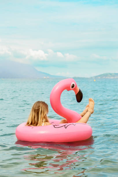 istock Relaxing blond in pink flamingo 1131093621