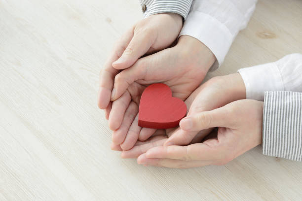 istock Heart object covered by man and woman's hands 1131094477