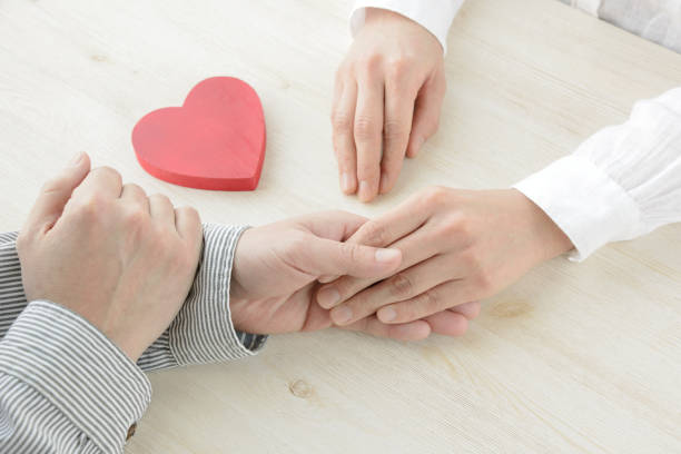 istock Heart object covered by man and woman's hands 1131094493
