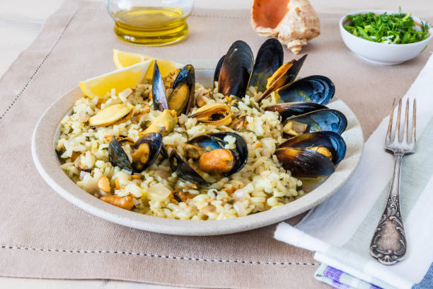 istock Lemon rice with mussels, midopilafo in a plate on a light tablecloth - greek dish 1131094986