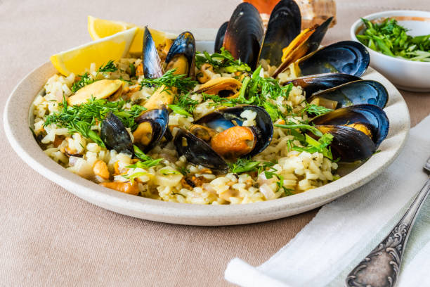 istock Lemon rice with mussels, midopilafo in a plate on a light tablecloth - greek dish 1131095005
