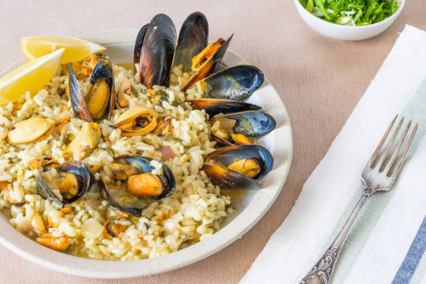 istock Lemon rice with mussels, midopilafo in a plate on a light tablecloth - greek dish 1131095037
