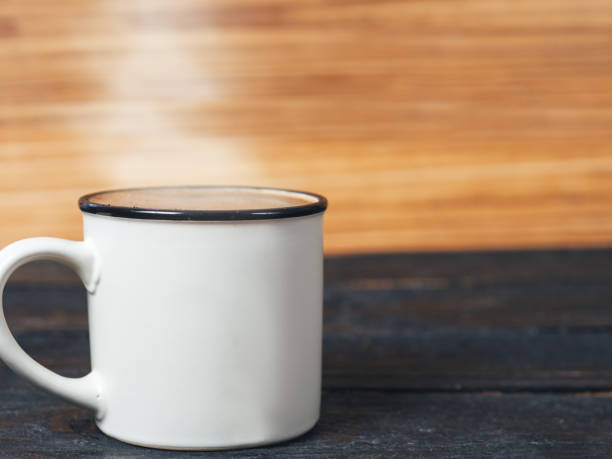 istock Mug of freshly brewed coffee on a wooden table with copyspace 1131095884