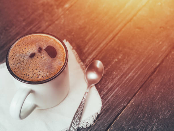 istock Mug of freshly brewed coffee on a wooden table with copyspace 1131095893