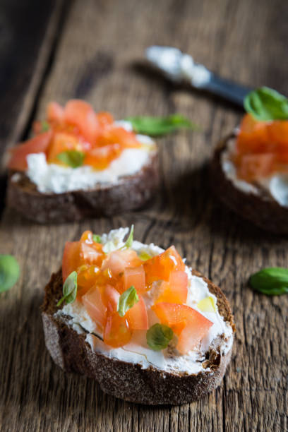 istock Light sandwich with cream cheese, tomatoes and basil 1131096114