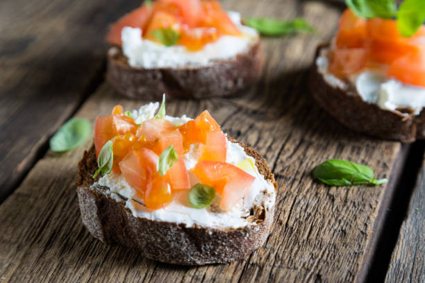 istock Light sandwich with cream cheese, tomatoes and basil 1131096134