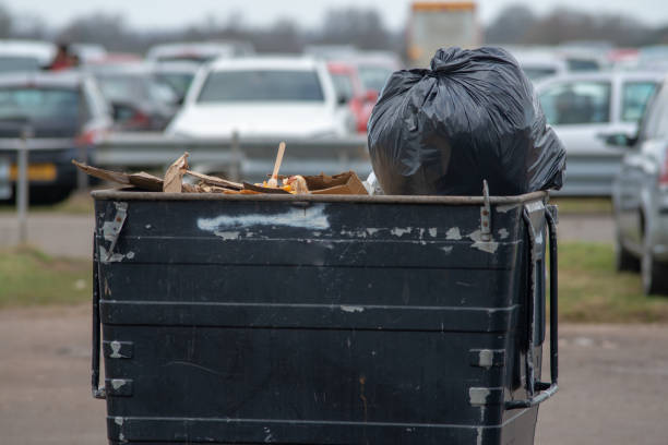 large black steel trash can containing black plastic rubbish bag close up of black metal dumpster bin containing assorted waste for recycling and refuse collection large dumpster stock pictures, royalty-free photos & images